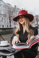 Frederique is a wide brim, side sweep felt hat for women in wine red